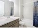 Bathroom featuring modern vanity, shower with curtain, and neutral finishes at 3901 Tour Trce, Land O Lakes, FL 34638