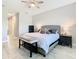 Bedroom with king bed, bench, and neutral color scheme, offering a serene retreat at 3901 Tour Trce, Land O Lakes, FL 34638