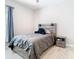Cozy bedroom features a modern gray bed frame and matching nightstand at 3901 Tour Trce, Land O Lakes, FL 34638