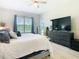 Bedroom with king bed, large window with blinds, and modern furniture at 3901 Tour Trce, Land O Lakes, FL 34638