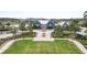 Areal shot of a stylish community clubhouse featuring well-manicured grounds and a serene lake in the distance at 3901 Tour Trce, Land O Lakes, FL 34638