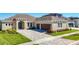 Beautiful home features a paver driveway, attached two-car garage, and well-maintained landscaping at 3901 Tour Trce, Land O Lakes, FL 34638