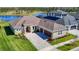 A well-manicured lawn and brick driveway lead to this beautiful single-Gathering home near a lake at 3901 Tour Trce, Land O Lakes, FL 34638