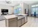 Bright and airy kitchen island overlooking the spacious living and dining areas with lots of natural light at 3901 Tour Trce, Land O Lakes, FL 34638
