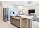Modern kitchen featuring a large stainless steel farmhouse sink, stainless steel appliances and gray cabinetry at 3901 Tour Trce, Land O Lakes, FL 34638