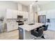 A modern kitchen featuring white cabinets, a quartz countertop island, and stainless steel appliances at 3901 Tour Trce, Land O Lakes, FL 34638