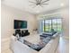 Well-lit living room with a sectional sofa, large TV, and sliding doors opening to the outdoor space at 3901 Tour Trce, Land O Lakes, FL 34638