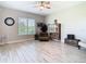 Bright living room features tile floors, large window, ceiling fan, and unique decorative accents at 3901 Tour Trce, Land O Lakes, FL 34638