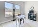 Bright office space features two sunny windows with desk, chair, and shelving at 3901 Tour Trce, Land O Lakes, FL 34638