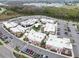 Aerial view of a shopping center showcasing diverse retailers and ample parking at 3901 Tour Trce, Land O Lakes, FL 34638