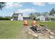 Spacious backyard with fire pit and red Adirondack chairs at 423 E County Line Rd, Lutz, FL 33549