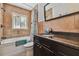 Cozy bathroom showcasing a shower-tub combo, tiled walls, and a dark vanity with granite counters at 4659 Helena Ne St, St Petersburg, FL 33703