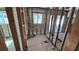 Unfinished bathroom showcasing removed drywall, exposed wooden beams, a window, and tile floor at 4659 Helena Ne St, St Petersburg, FL 33703