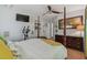 Bedroom with four-poster bed, mounted TV, exercise equipment and large dresser at 4659 Helena Ne St, St Petersburg, FL 33703
