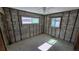 Unfinished bedroom with exposed concrete block walls and two framed windows providing natural light at 4659 Helena Ne St, St Petersburg, FL 33703