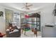 Playful bedroom featuring a bunk bed, gray accent chair, and bright dinosaur themed curtains at 4659 Helena Ne St, St Petersburg, FL 33703