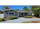 Charming single-story home featuring a gray exterior, well-maintained landscaping, and a cozy front entrance at 4659 Helena Ne St, St Petersburg, FL 33703