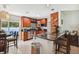 Open kitchen with stainless steel appliances, granite countertops, and a dining area at 4659 Helena Ne St, St Petersburg, FL 33703