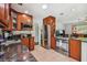 Well-lit kitchen with stainless steel appliances, granite countertops, and wooden cabinets at 4659 Helena Ne St, St Petersburg, FL 33703