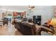 Inviting living room and kitchen layout featuring a plush leather sofa, ceiling fan, and tile flooring at 4659 Helena Ne St, St Petersburg, FL 33703