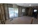 Unfinished living space with exposed beams, a sliding glass door to the pool area, and tile flooring at 4659 Helena Ne St, St Petersburg, FL 33703