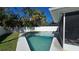 Backyard featuring a private pool, lush palm trees, white fence and screened in patio at 4659 Helena Ne St, St Petersburg, FL 33703