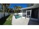 Backyard with a private pool, white fence, and screened in lanai at 4659 Helena Ne St, St Petersburg, FL 33703
