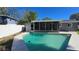 Backyard featuring a private pool, a screened-in patio and a white fence at 4659 Helena Ne St, St Petersburg, FL 33703