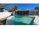 Relaxing kidney-shaped pool with screened enclosure and patio at 4659 Helena Ne St, St Petersburg, FL 33703