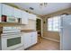 White kitchen with stove, microwave, and refrigerator at 5219 Dr Martin Luther King Jr N St, St Petersburg, FL 33703