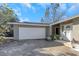 Attached garage with white door and driveway at 904 Normandy Rd, Clearwater, FL 33764