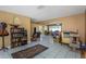 Living room with bookcase and view into another area at 904 Normandy Rd, Clearwater, FL 33764