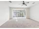 Bright bedroom with neutral carpet, ceiling fan, and sliding doors to a screened porch at 10135 Post Harvest Dr, Riverview, FL 33578