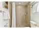 Clean bathroom with shower stall, toilet and granite vanity at 11605 Gulf Blvd # 507, Treasure Island, FL 33706