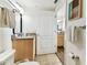 Bathroom with granite-top vanity, toilet and view of second sink at 11605 Gulf Blvd # 507, Treasure Island, FL 33706