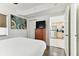 Bedroom with dresser, queen bed and kitchen view at 11605 Gulf Blvd # 507, Treasure Island, FL 33706