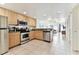 Modern kitchen with stainless steel appliances and light wood cabinets at 11605 Gulf Blvd # 507, Treasure Island, FL 33706