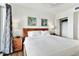 Main bedroom with king bed, wood floors, and ocean view at 11605 Gulf Blvd # 507, Treasure Island, FL 33706