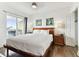 Spacious main bedroom with king-size bed and access to balcony at 11605 Gulf Blvd # 507, Treasure Island, FL 33706