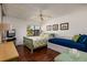 Bedroom with a green sleigh bed, daybed, and wood flooring at 12300 Vonn Rd # 9205, Largo, FL 33774