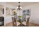Bright dining area with glass table and four chairs, kitchen view at 12300 Vonn Rd # 9205, Largo, FL 33774