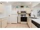 Bright kitchen with white cabinets, appliances, and tile flooring at 12300 Vonn Rd # 9205, Largo, FL 33774