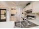 Kitchen with white cabinets, appliances, and tile flooring at 12300 Vonn Rd # 9205, Largo, FL 33774