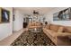 Spacious living room featuring brown sofas and ornate patterned rug at 12300 Vonn Rd # 9205, Largo, FL 33774