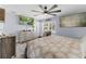 Main bedroom with a large TV, ceiling fan and dresser at 1308 Oakhill St, Seffner, FL 33584