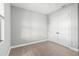 Simple bedroom with wood-look floors and double doors at 15136 Hennipen Cir, Port Charlotte, FL 33981