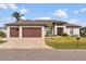 A charming single-story home with a two-car garage and well-manicured lawn at 15136 Hennipen Cir, Port Charlotte, FL 33981