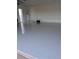 Spacious garage with sleek, epoxy-coated flooring, water heater, and ample room for storage and parking at 15136 Hennipen Cir, Port Charlotte, FL 33981