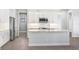 Modern kitchen with white cabinets and a large island at 15136 Hennipen Cir, Port Charlotte, FL 33981