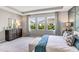 Spacious bedroom featuring plush carpet, tray ceilings, and an abundance of natural light at 16030 10Th E Ave, Bradenton, FL 34212